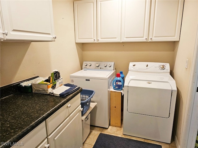 washroom featuring cabinets, separate washer and dryer, and light tile patterned flooring