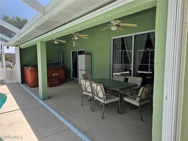 view of patio featuring ceiling fan and a hot tub