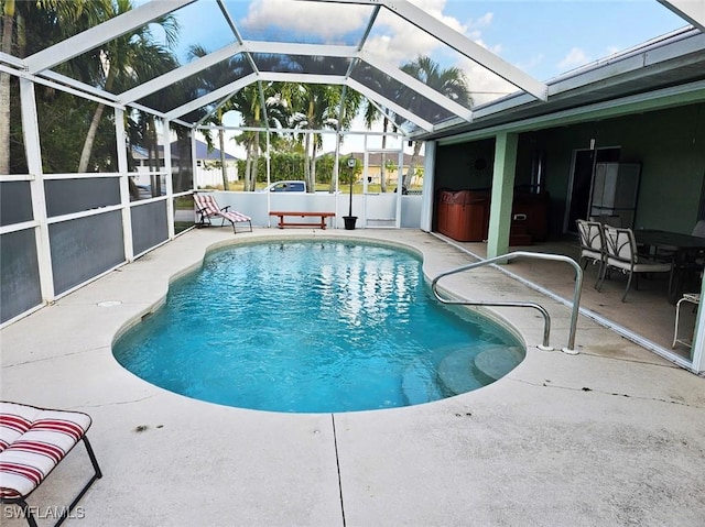 view of swimming pool featuring glass enclosure, a jacuzzi, and a patio