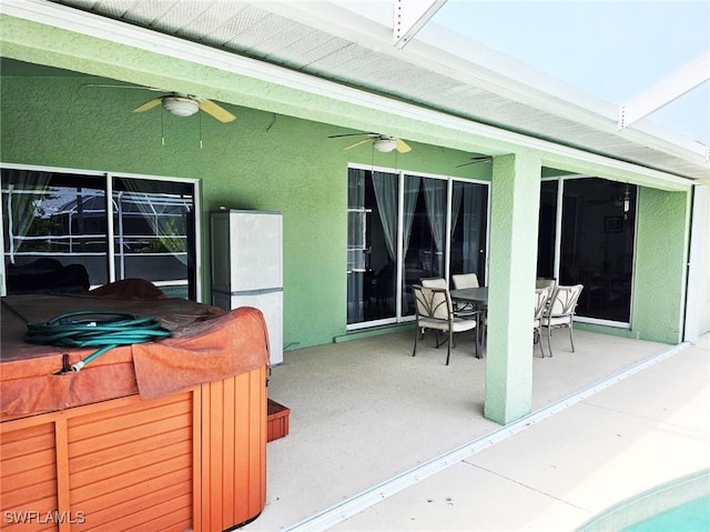 view of patio / terrace featuring ceiling fan and a bar