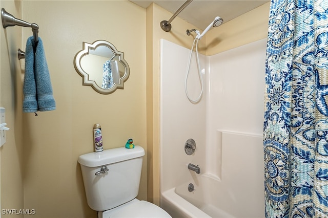 bathroom with shower / bathtub combination with curtain and toilet