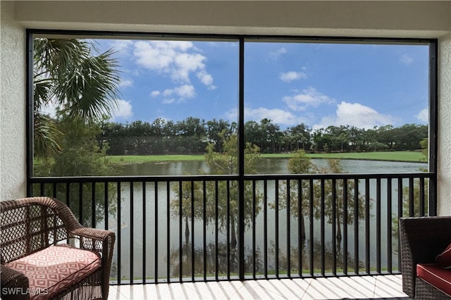 sunroom / solarium featuring a water view