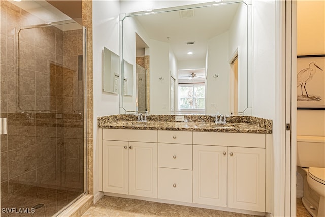 bathroom featuring vanity, tile patterned flooring, ceiling fan, toilet, and an enclosed shower