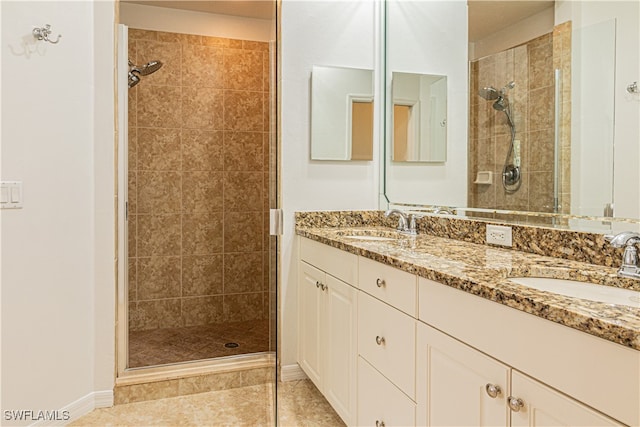 bathroom with vanity, an enclosed shower, and tile patterned floors