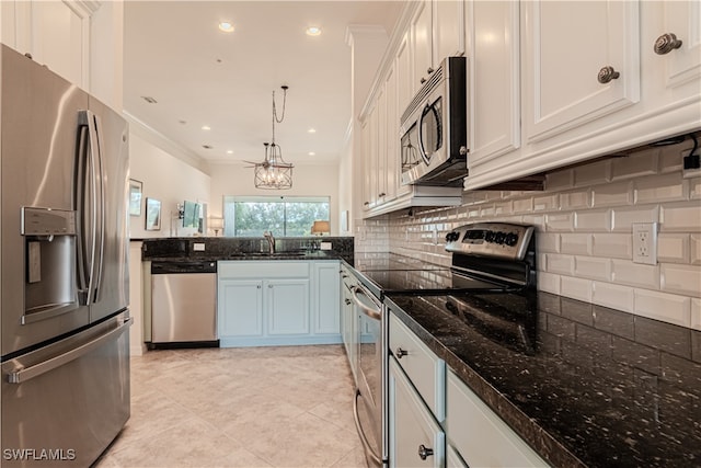 kitchen featuring white cabinets, stainless steel appliances, pendant lighting, and sink