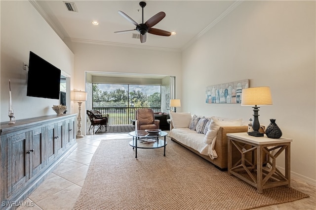 living room featuring ornamental molding, light tile patterned flooring, a towering ceiling, and ceiling fan