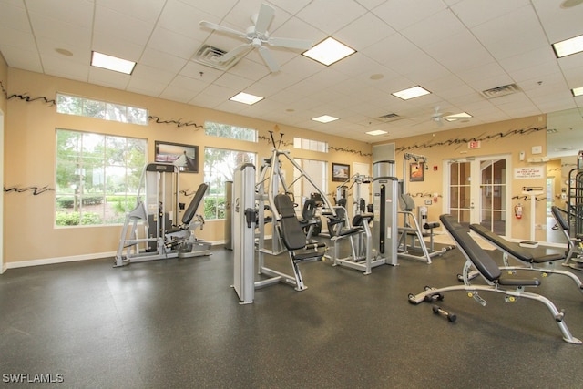 gym featuring ceiling fan and a paneled ceiling