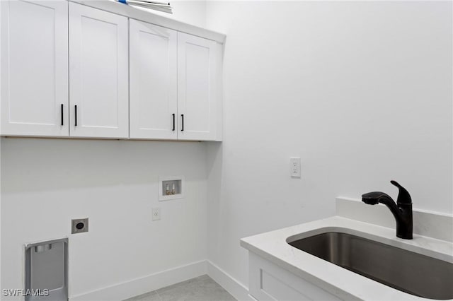 washroom with electric dryer hookup, cabinets, sink, washer hookup, and light tile patterned flooring