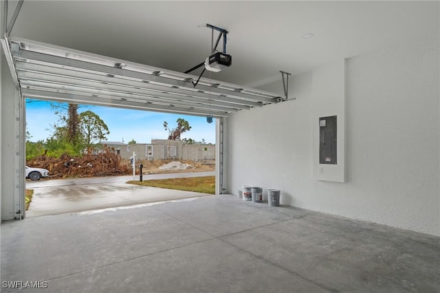 garage with electric panel and a garage door opener