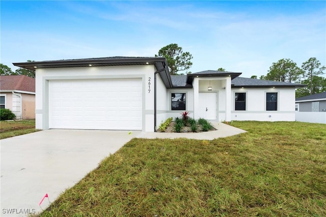 view of front of property with a garage and a front lawn