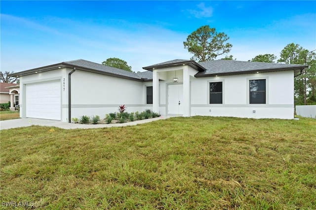 ranch-style home featuring a garage and a front lawn