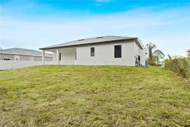 back of house with a lawn