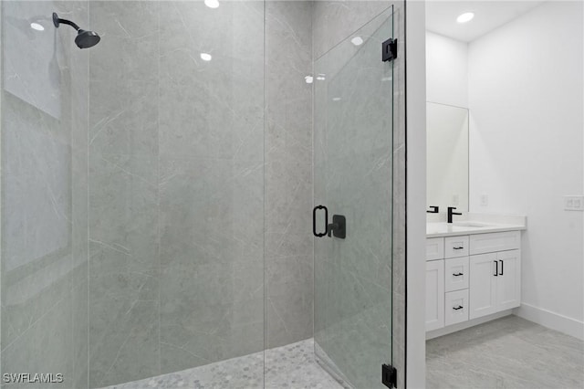 bathroom featuring vanity and an enclosed shower