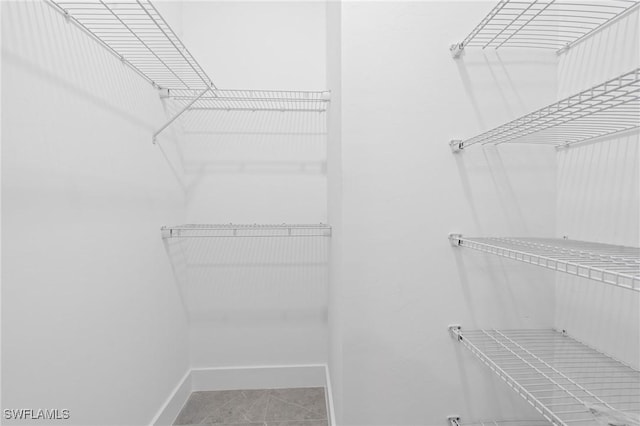 spacious closet featuring tile patterned floors