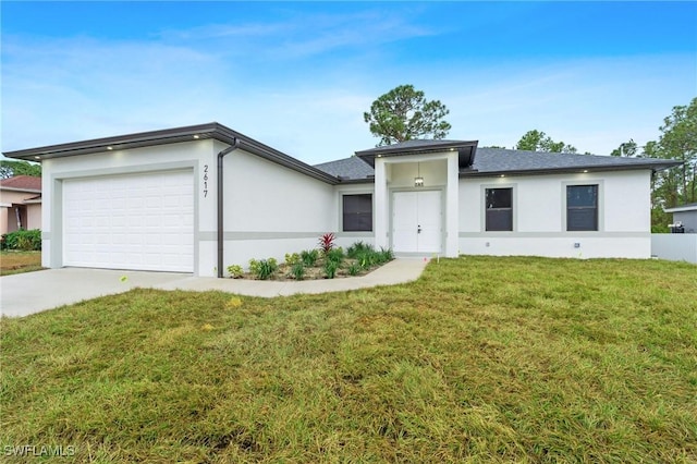 view of front of house featuring a garage and a front lawn