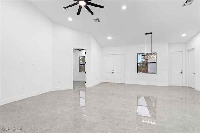 unfurnished living room with ceiling fan and vaulted ceiling