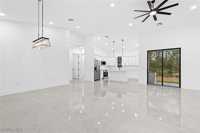 unfurnished living room with ceiling fan and lofted ceiling