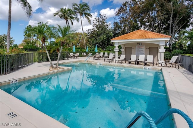 community pool featuring a patio area and fence