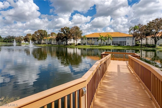 dock area featuring a water view and a residential view