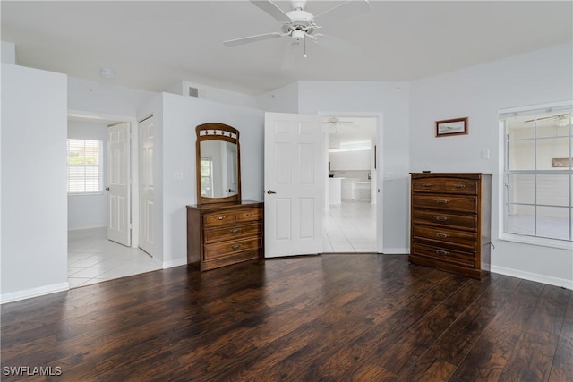 unfurnished bedroom with ceiling fan, baseboards, and wood finished floors