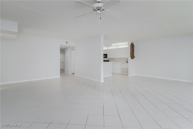 unfurnished room featuring baseboards and a ceiling fan