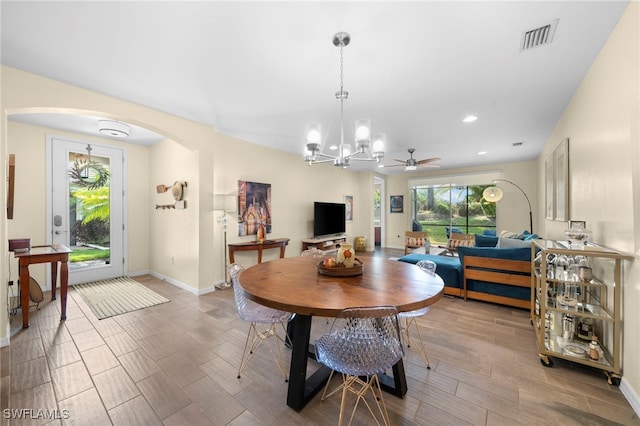 dining space featuring plenty of natural light and ceiling fan with notable chandelier