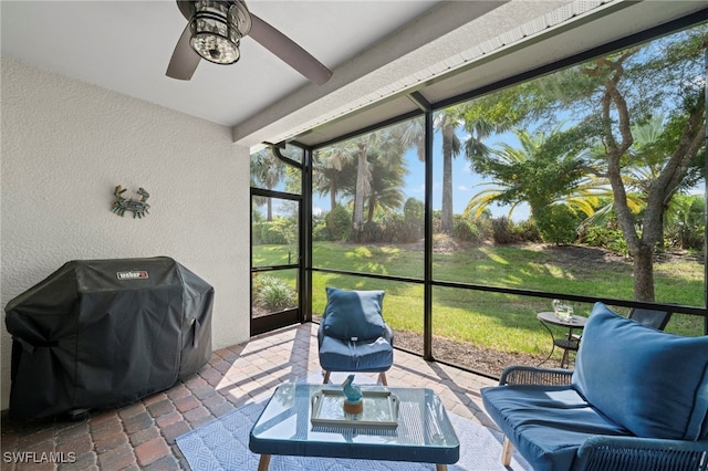 sunroom / solarium featuring ceiling fan