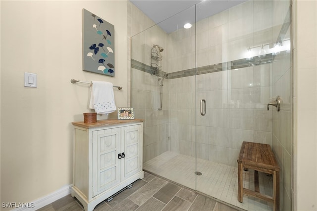 bathroom featuring a shower with shower door