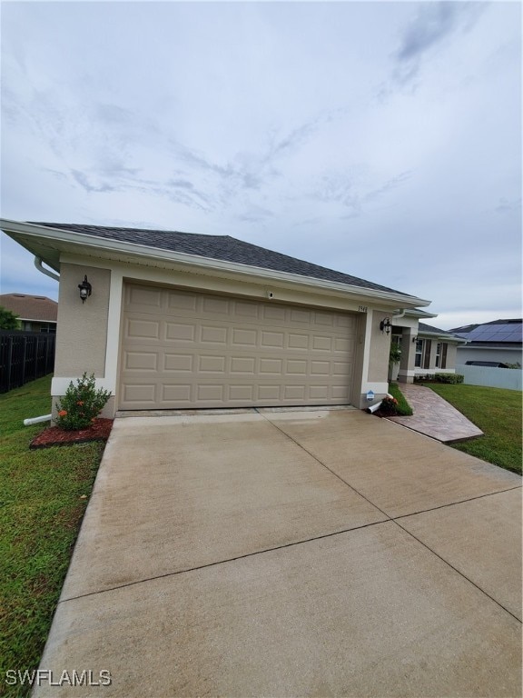 view of front of property with a garage and a front lawn