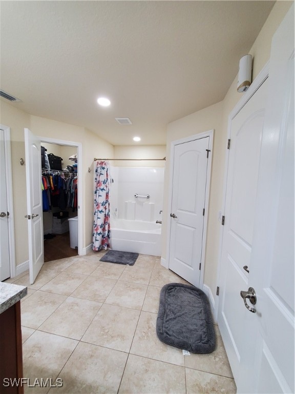 bathroom featuring vanity, tile patterned flooring, and shower / tub combo with curtain