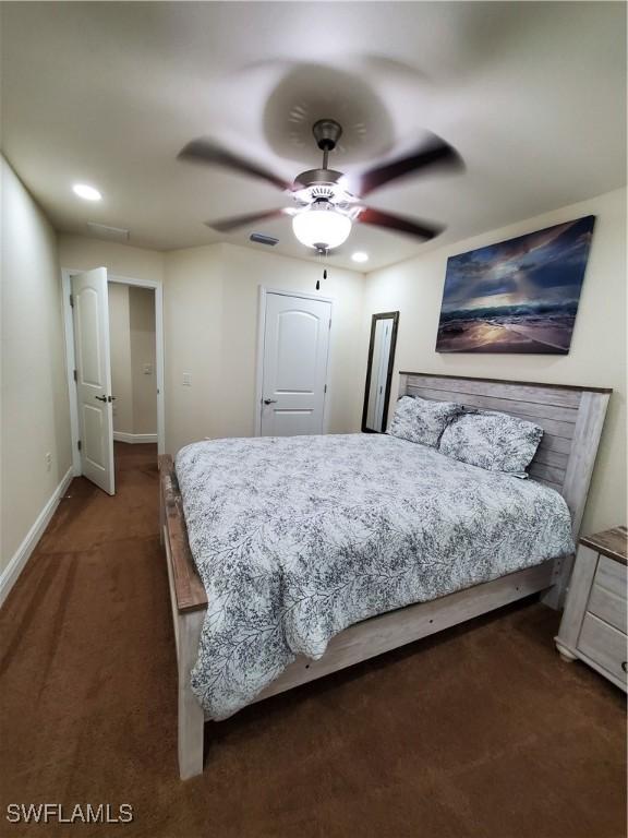 bedroom with dark carpet and ceiling fan