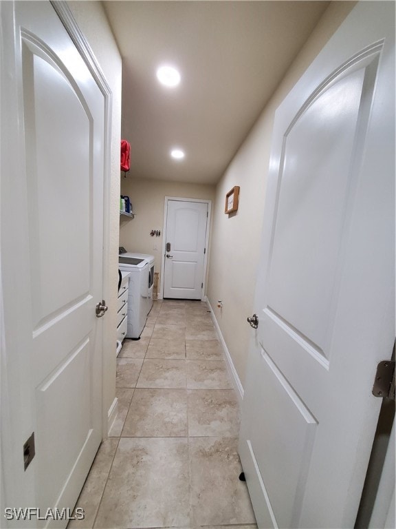 interior space featuring light tile patterned floors and washing machine and clothes dryer