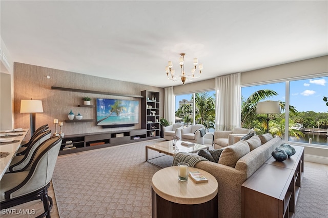 living room featuring a notable chandelier and light colored carpet