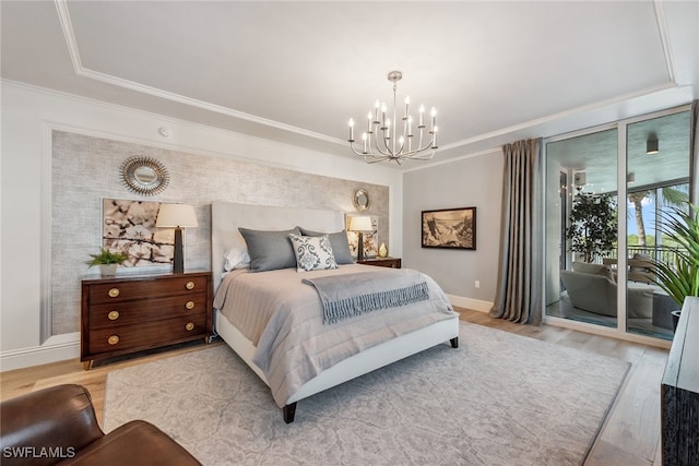 bedroom with an inviting chandelier, light hardwood / wood-style floors, access to exterior, and crown molding