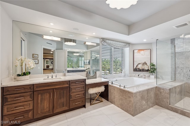 bathroom featuring vanity and separate shower and tub