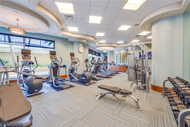 gym with light colored carpet and a paneled ceiling