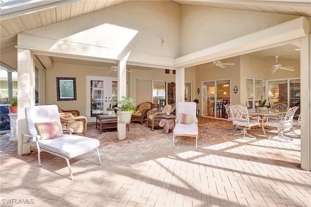 interior space featuring ceiling fan and high vaulted ceiling