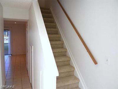 stairs with tile patterned flooring