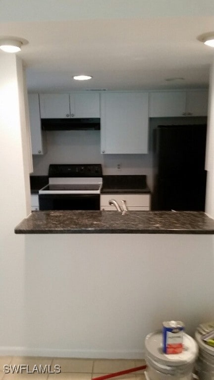 kitchen with black appliances and tile patterned floors