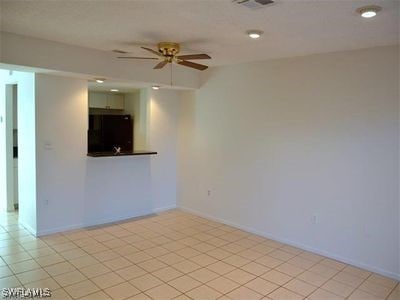 unfurnished room with ceiling fan and light tile patterned flooring