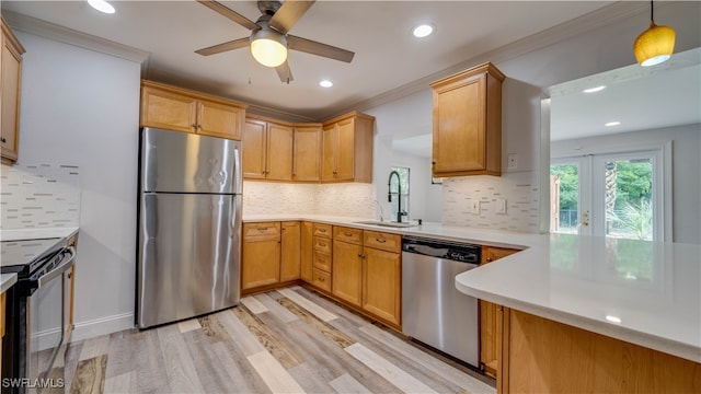 kitchen featuring hanging light fixtures, decorative backsplash, stainless steel appliances, ceiling fan, and sink