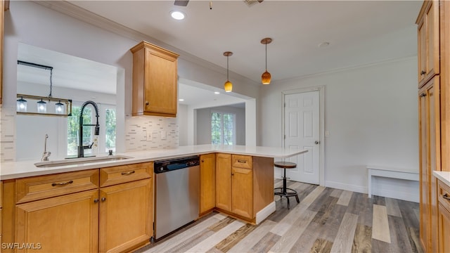 kitchen featuring light wood-type flooring, kitchen peninsula, hanging light fixtures, backsplash, and stainless steel dishwasher