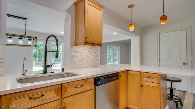 kitchen with kitchen peninsula, sink, tasteful backsplash, light hardwood / wood-style flooring, and dishwasher