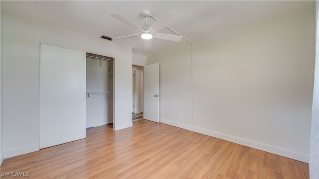 unfurnished bedroom featuring light hardwood / wood-style flooring, a closet, and ceiling fan