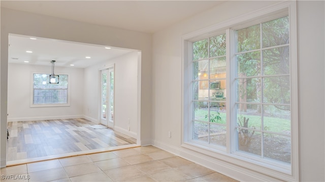 spare room with a healthy amount of sunlight and light hardwood / wood-style floors