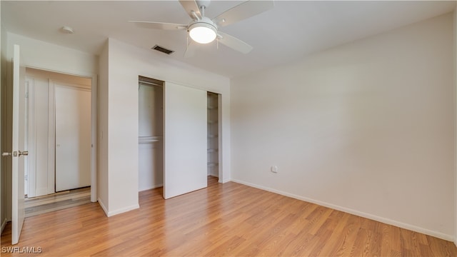 unfurnished bedroom with ceiling fan, light hardwood / wood-style flooring, and a closet