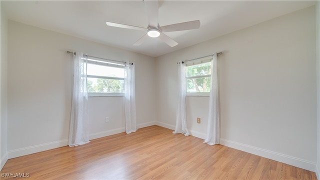 empty room with ceiling fan, light hardwood / wood-style flooring, and a wealth of natural light