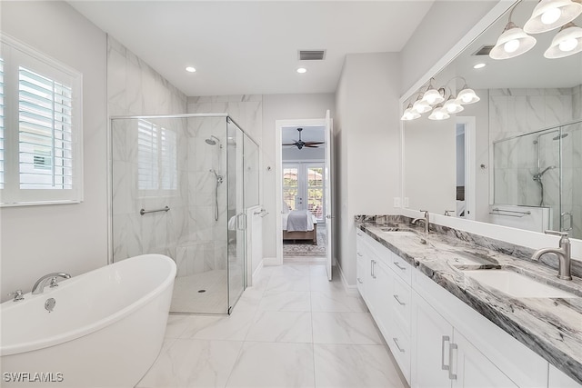 bathroom with ceiling fan with notable chandelier, a healthy amount of sunlight, vanity, and separate shower and tub