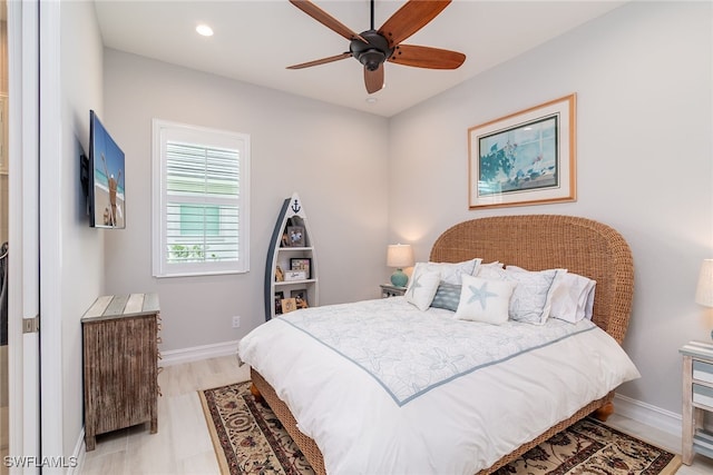 bedroom with light hardwood / wood-style flooring and ceiling fan