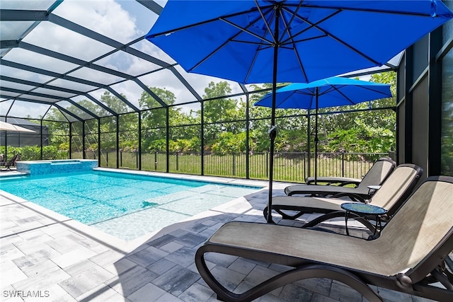 view of pool featuring glass enclosure and a patio